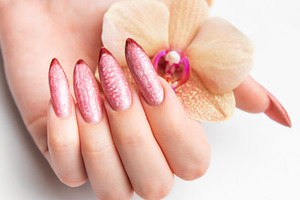 Woman's hand holding orchid showcasing beautiful manicure, a Beauty & Fashion Photo by Olena Rudo