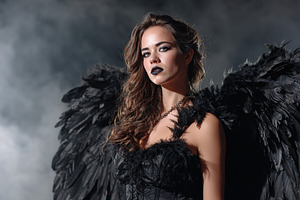 Mysterious woman with black wings poses in a dramatic setting at night, a Person Photo by AlyaAnd