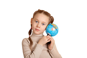 Young girl with pigtails gently holding a small globe, symbolizi, a School & Education Photo by Ales Munt