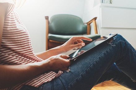 Hipster girl using tablet pc at home, a Technology Photo by ImYanis