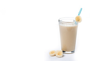 Fresh and healthy banana smoothie in glass isolated on white background., a Food & Drink Photo by etorres69