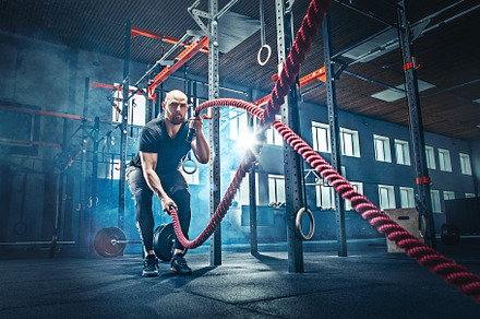 Men with battle rope battle ropes exercise in the fitness gym containing gym, a Sports & Recreation Photo by Volodymyr Melnyk
