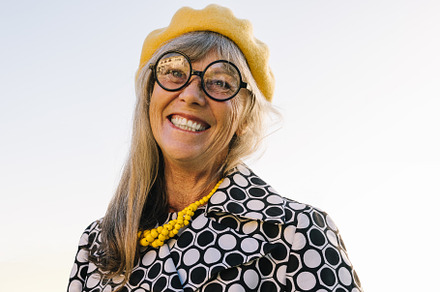 Cheerful senior woman smiling happily outdoors, a Person Photo by Jacob Lund