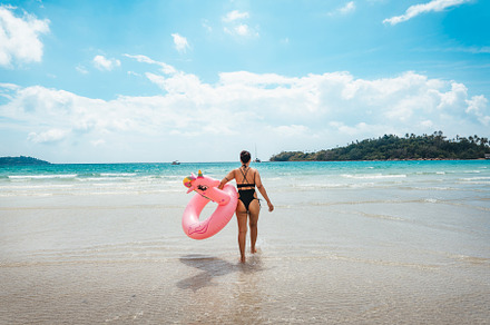 Summer travel, woman holding an inner tube, walking in the middl, a Nature Photo by Art Rachen