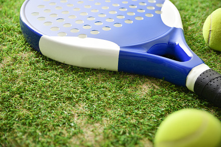 Padel racket and balls on outdoor artificial grass elevated view, a Sports & Recreation Photo by Davizro's Market