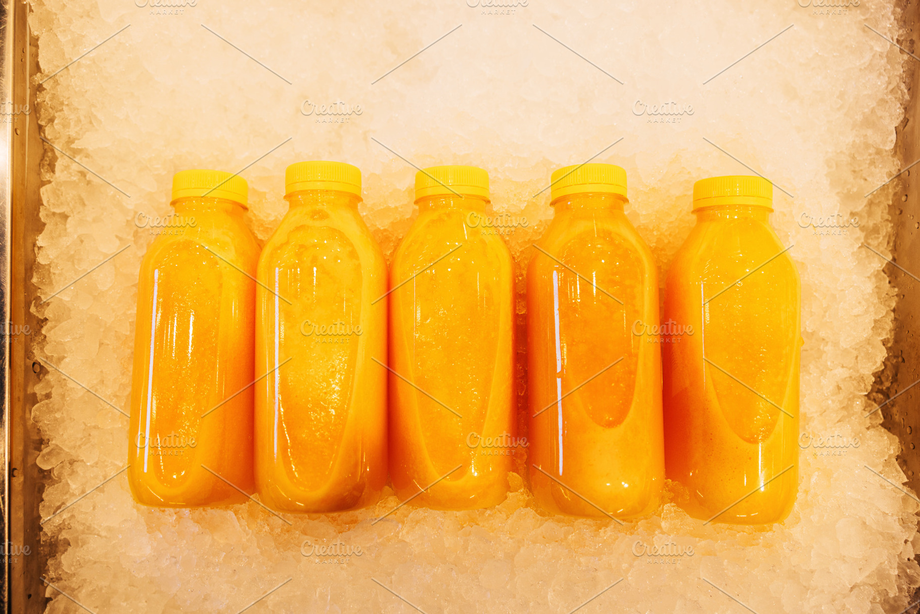 Five bottles with orange juice, a Food & Drink Photo by Artem Varnitsin