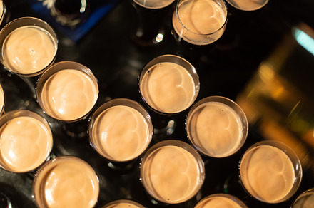 Beer glasses with dark beer are on t containing beer, glass, and alcohol, a Food & Drink Photo by oleghz