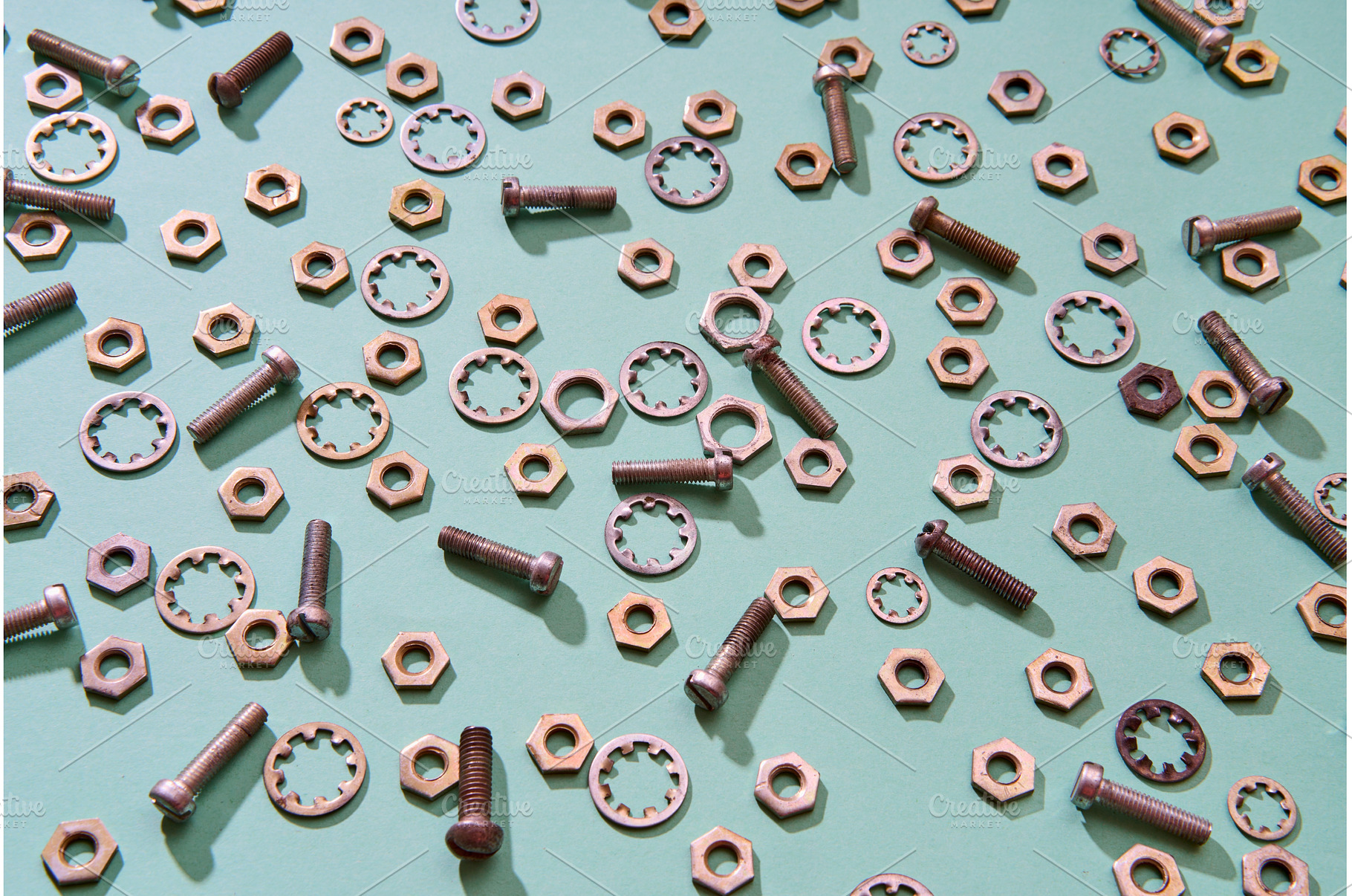 Scattered metal nuts bolts and, an Industrial Photo by Gladkov photography