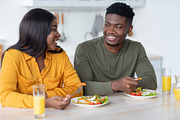Domestic Morning. Happy Black Millennial Spouses Eating Breakfast In Kitchen, a Photo by Prostock-Studio (Thumbnail 3 of 3)