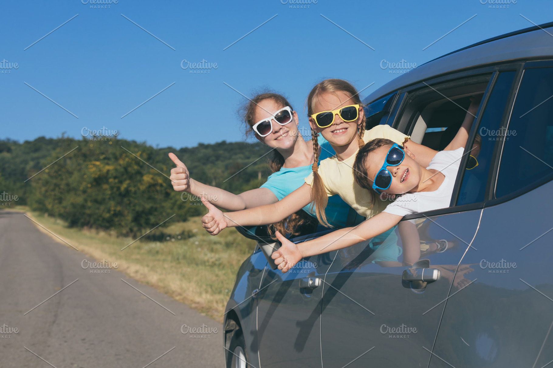 Happy kids sitting in the car featuring car, child, and family, a Person Photo by altanaka