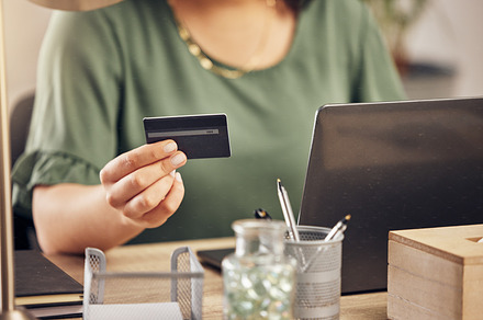 Hands, credit card and laptop on desk, payment and home office for online shopping, sale and banking on internet. Woman, pc and fintech app for cyber security, discount or deal with e commerce store, a Photo by Peopleimages.com
