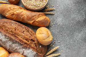Assortment of fresh baked bread, grain, and flour, a Food & Drink Photo by Olena Rudo