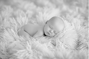 A newborn baby lies naked, a Person Photo by ZinetroN