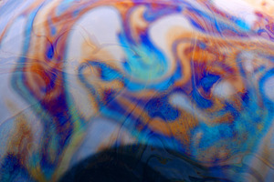 Vibrant abstract pattern with swirling blue, orange, and purple, a Background Photo by Ales Munt