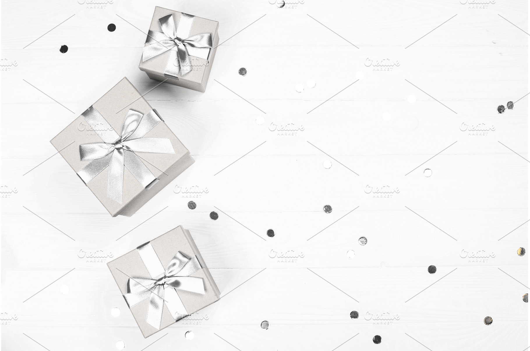 Silver gifts and confetti on white, a Holiday Photo by Anna Efetova