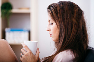 Woman drinking tea at home