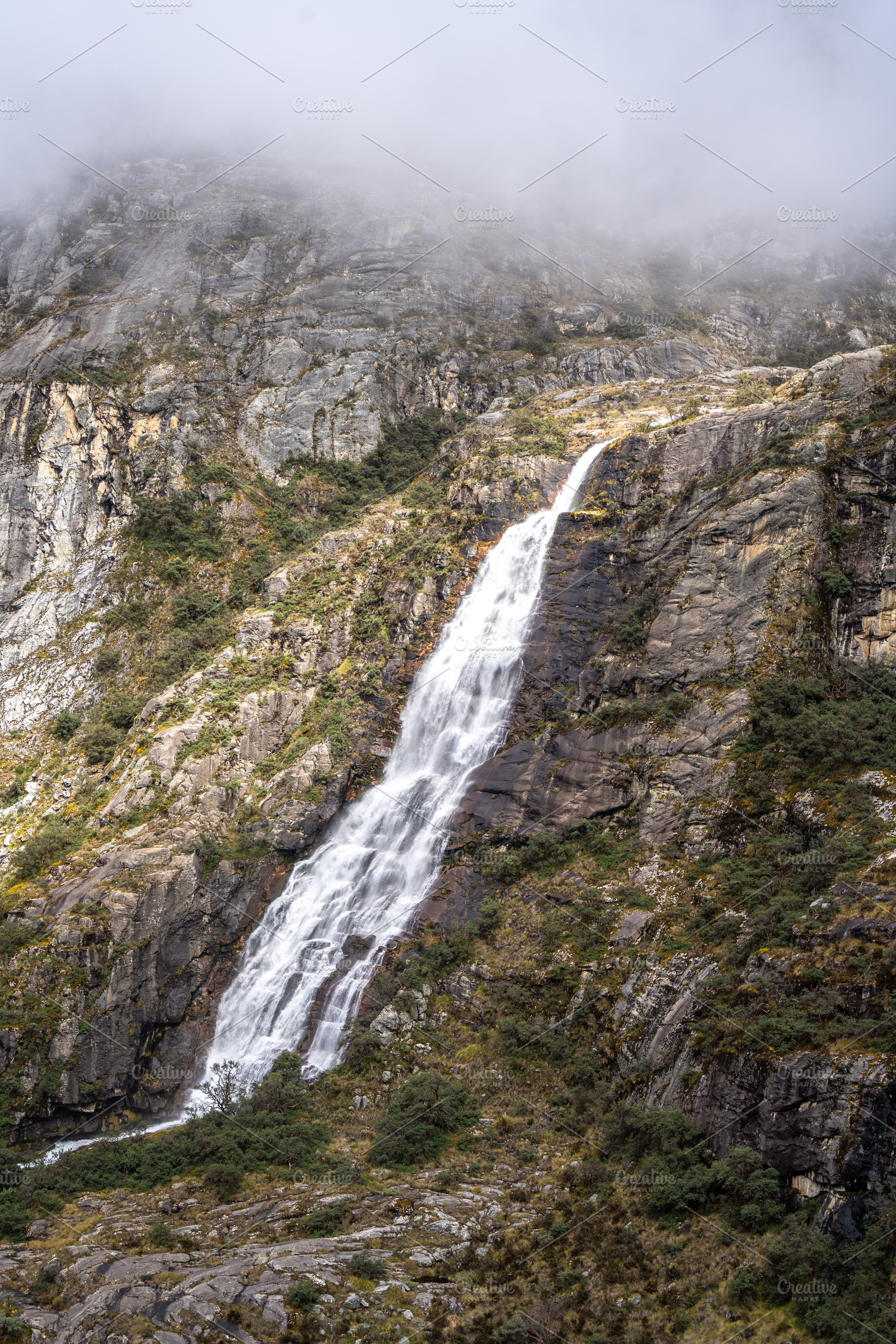Waterfall cascading from snowy mountains on the Laguna 69 trek,, a Nature Photo by GoodGoods