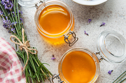 Jars with honey and fresh lavender flowers, a Food & Drink Photo by Olena Rudo