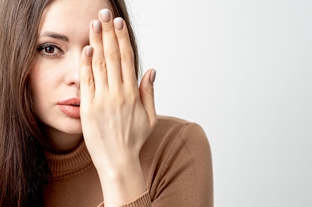 Woman covering half face with hand featuring woman, people, and human face, a Person Photo by okskukuruza