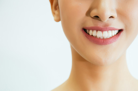 Closeup of young attractive woman with healthy teeth laughing with her hands, a Person Photo by Twinster Photo
