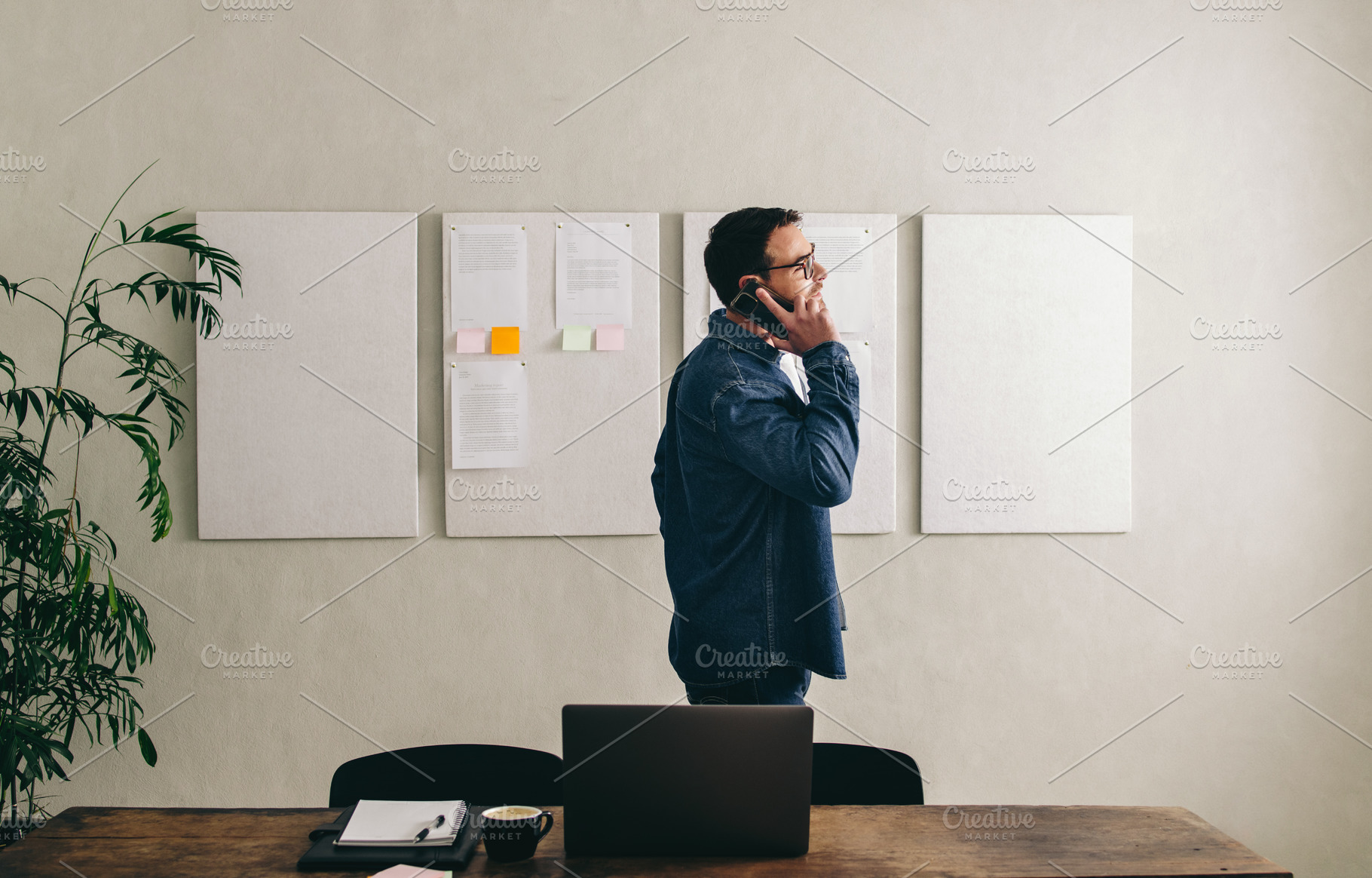 Young businessman talking on the phone in a creative office, a Person Photo by Jacob Lund