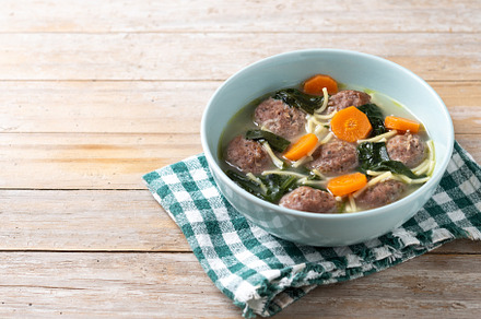Italian Wedding Soup with meatballs and spinach on wooden table, a Food & Drink Photo by etorres69
