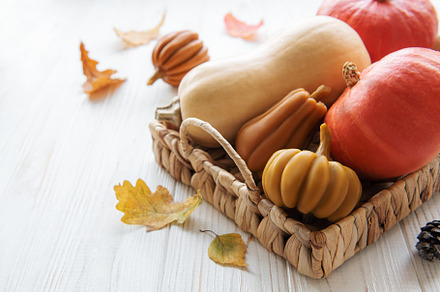 Autumn decorative pumpkins with fall leaves on wooden background, a Food & Drink Photo by Olena Rudo