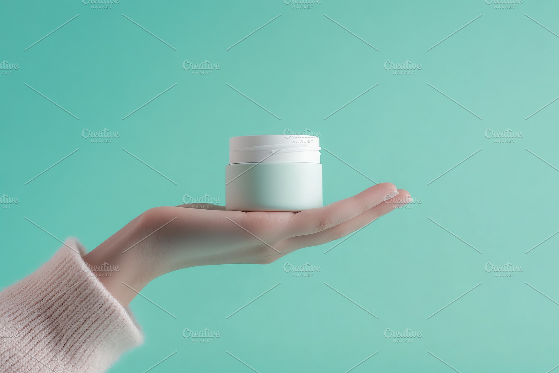 Female model hand holding cosmetic jar on mint background, a Beauty & Fashion Photo by AlyaAnd