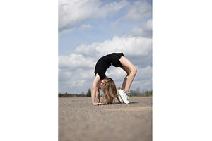 Little girl stands on her hands, a Nature Photo by Nenahliadava Design
