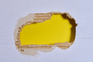 A torn hole in white paper with a yellow background inside. Copy, a Background Photo by ndanko