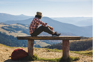 Male Hiker Resting on Top of the