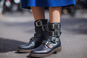 Stylish boots with buckles on street, a Photo by Beautiful things