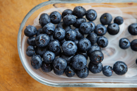 Fresh blueberries in a transparent plate on a wooden table. Top view, natural v, a Food & Drink Photo by Artsaba Family