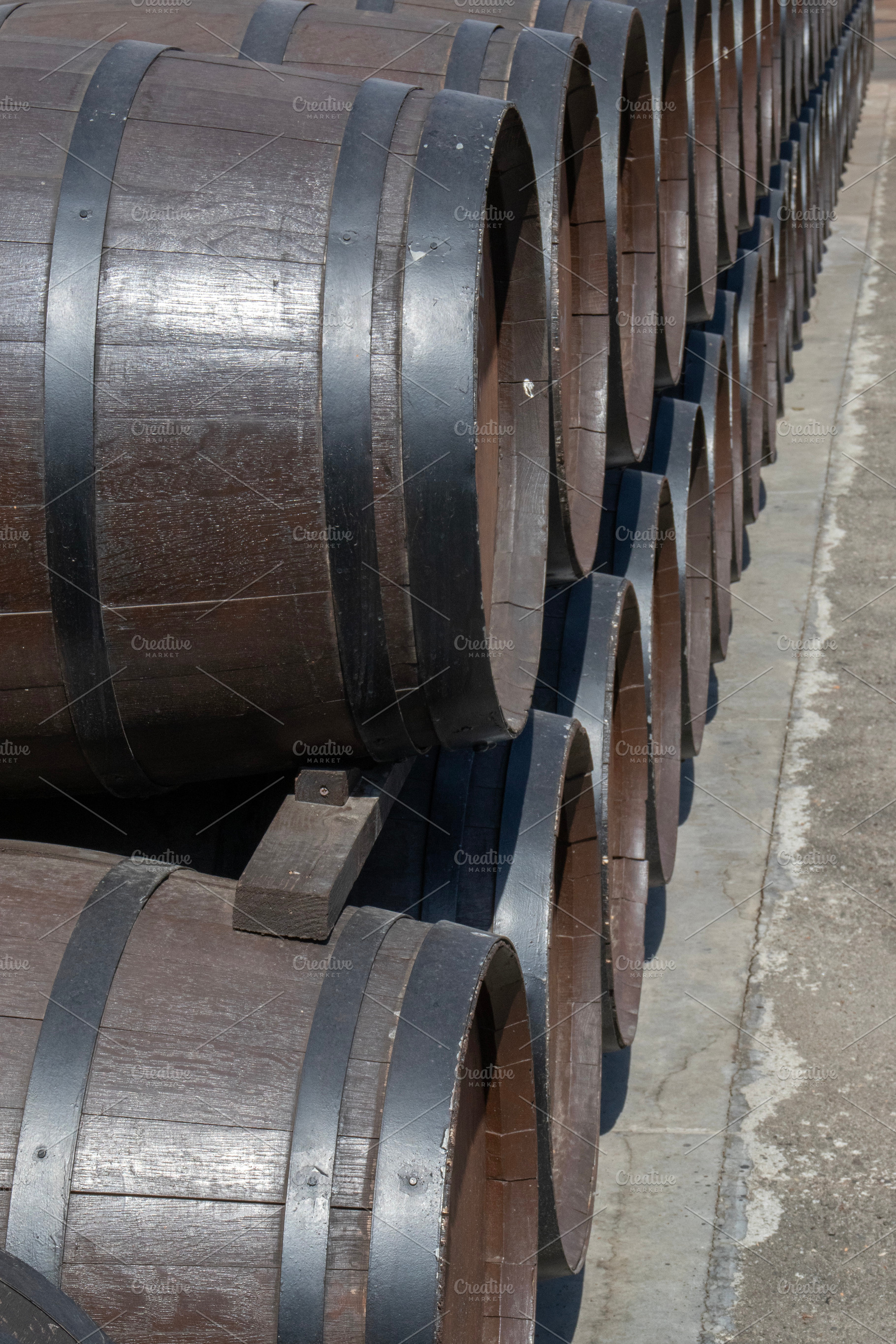 Oak barrels stand in two rows, a Food & Drink Photo by Schreibikus
