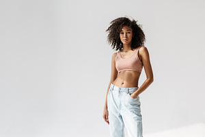 Young african woman wearing brassiere posing and looking at camera