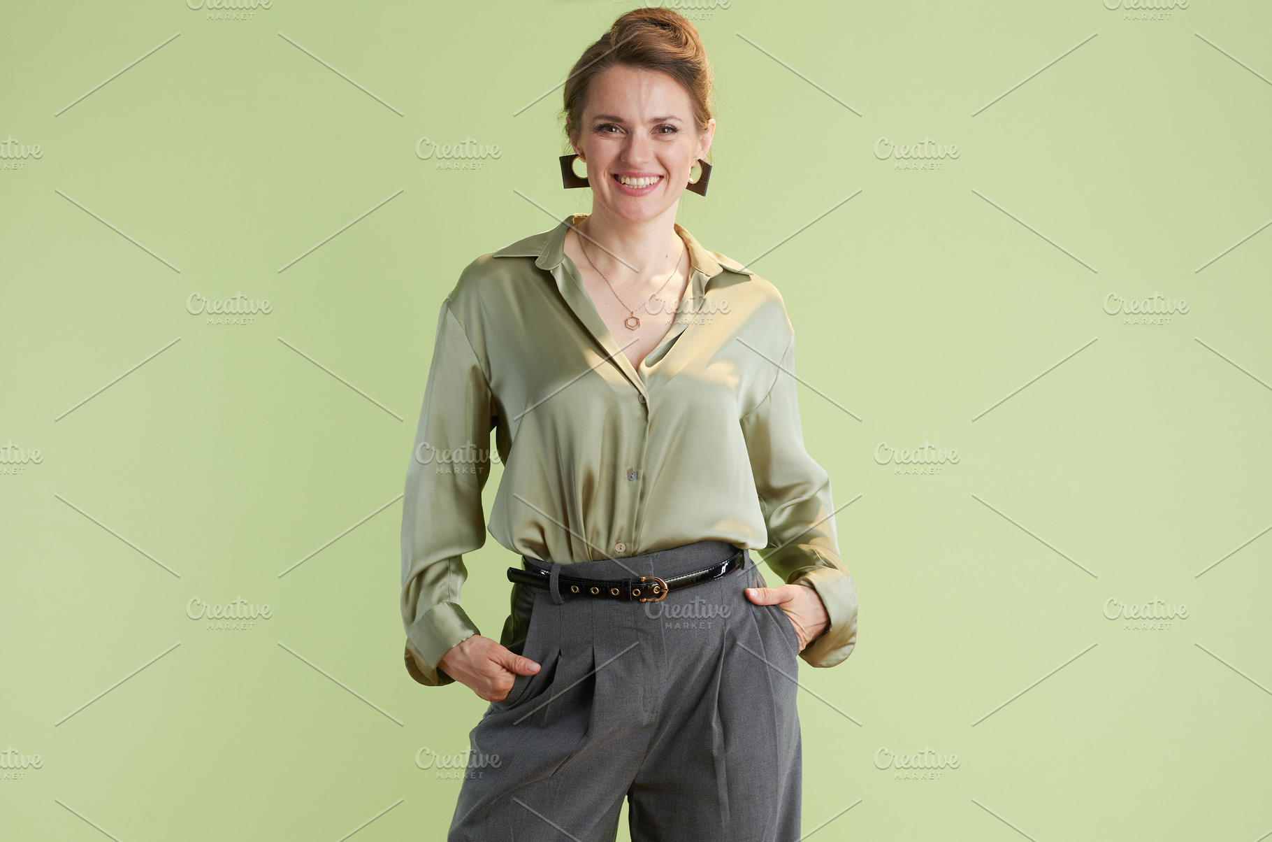 Confident woman in green blouse, a Person Photo by Alliance Images
