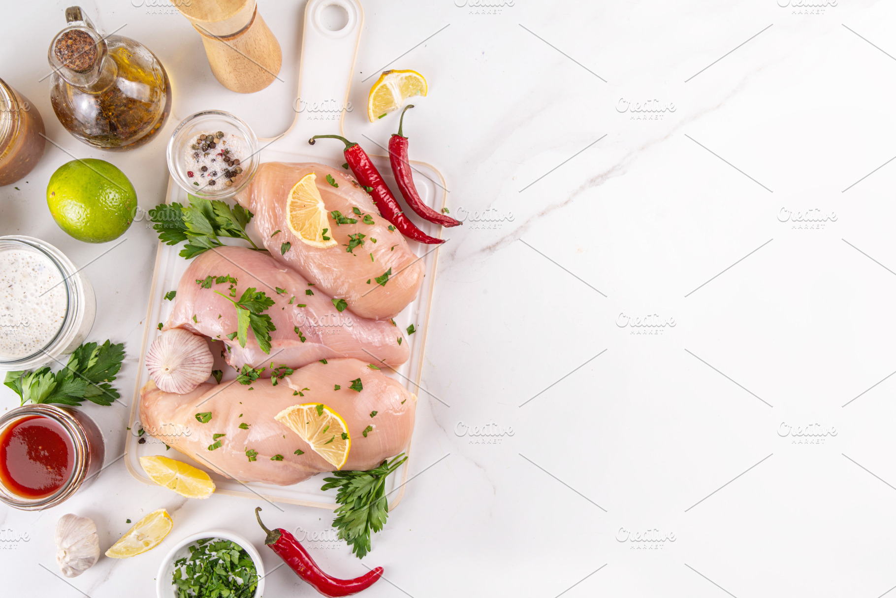 Fresh raw organic chicken breast fillet, with spices and condime, a Food & Drink Photo by Rimma