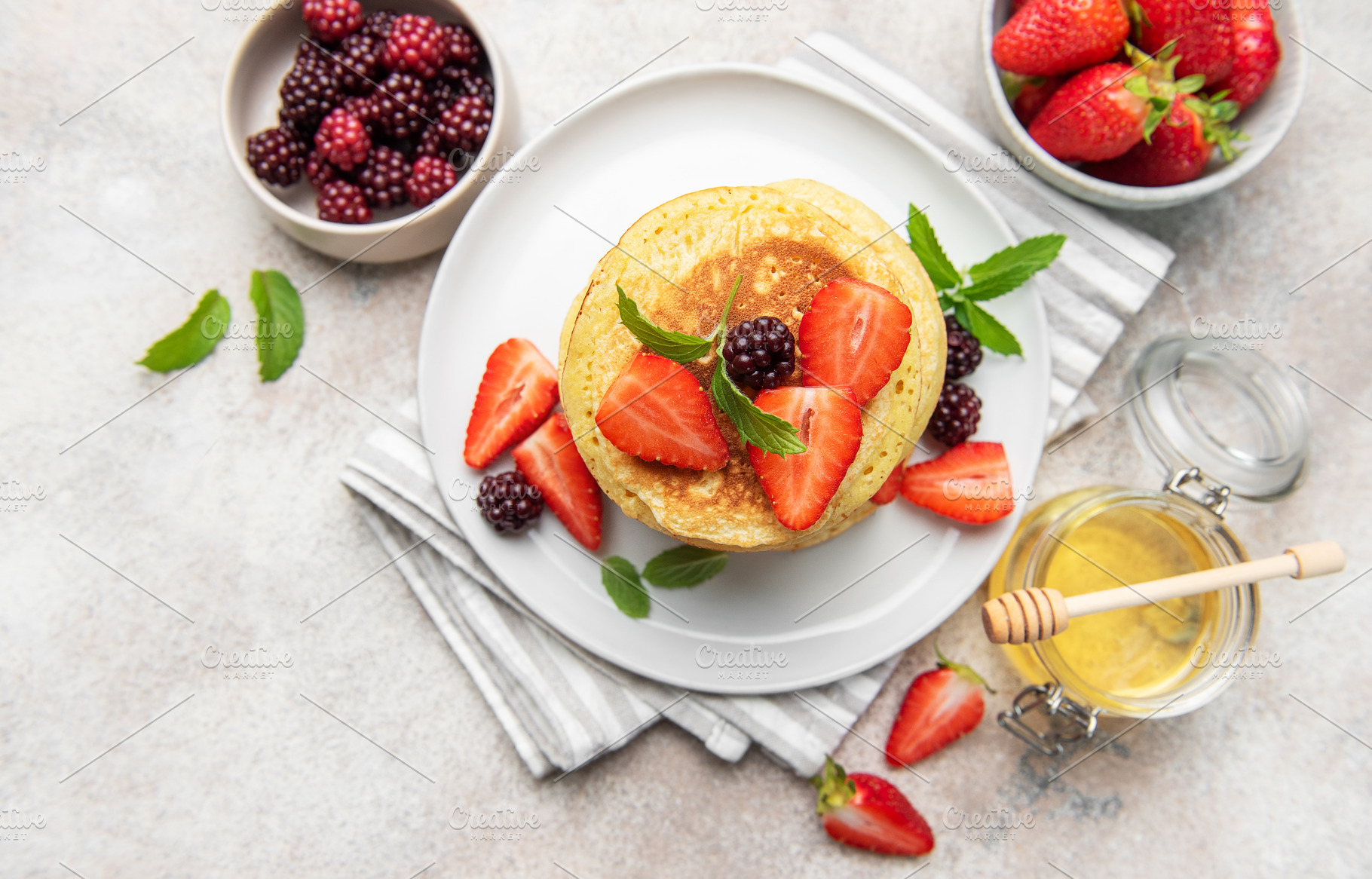 Pancakes with fresh strawberries blackberries honey mint, a Food & Drink Photo by Olena Rudo