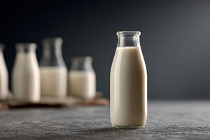 Milk bottle on a table with others, a Photo by Beautiful things