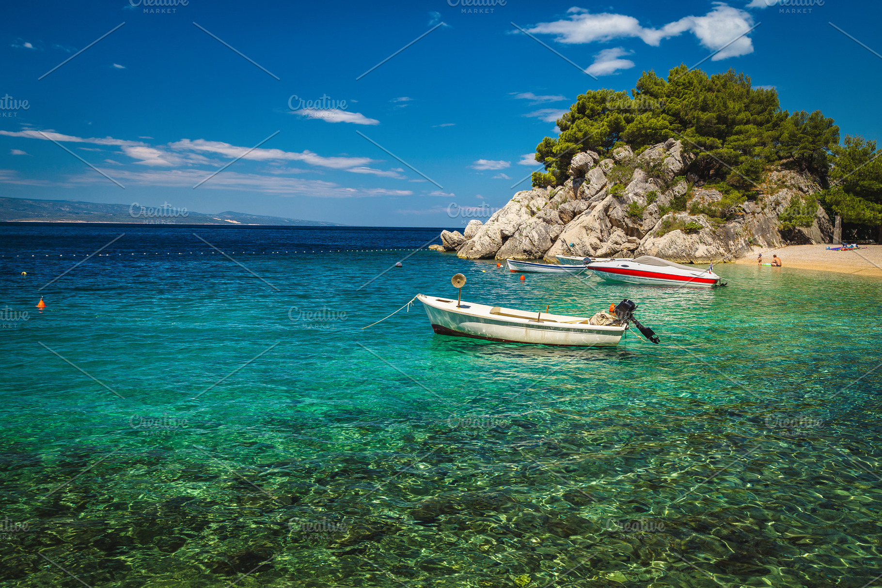 Beautiful beach and moored boats, a Nature Photo by Alpine Dreams
