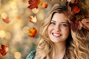 Attractive blonde woman smiling with autumn leaves in her hair a, a Person Photo by Studio ANNA