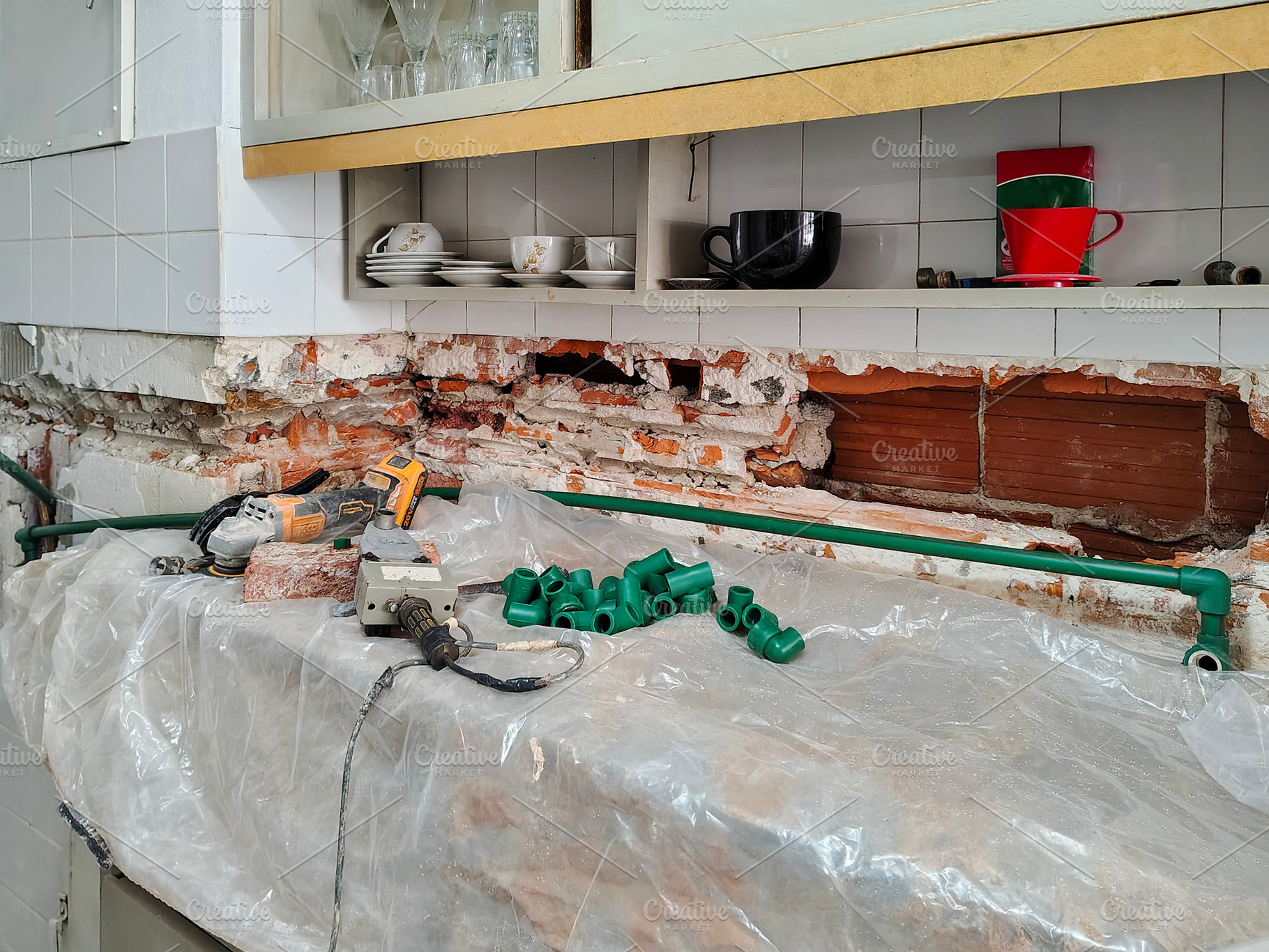 Exposed section of a wall undergoing plumbing work, an Industrial Photo by DanFLCreativo