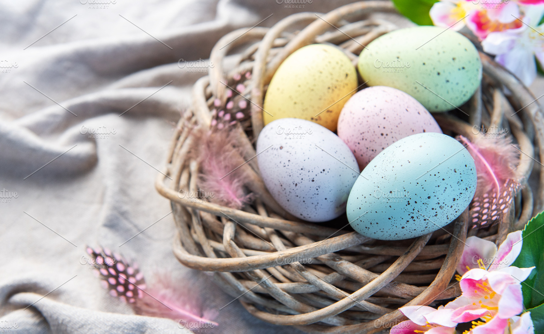 Pastel easter eggs in rustic wicker nest, a Holiday Photo by Olena Rudo