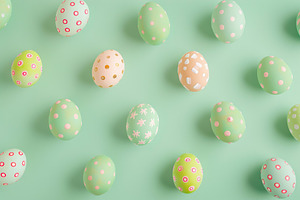Pattern of decorated easter eggs on green background, a Food & Drink Photo by AlyaAnd
