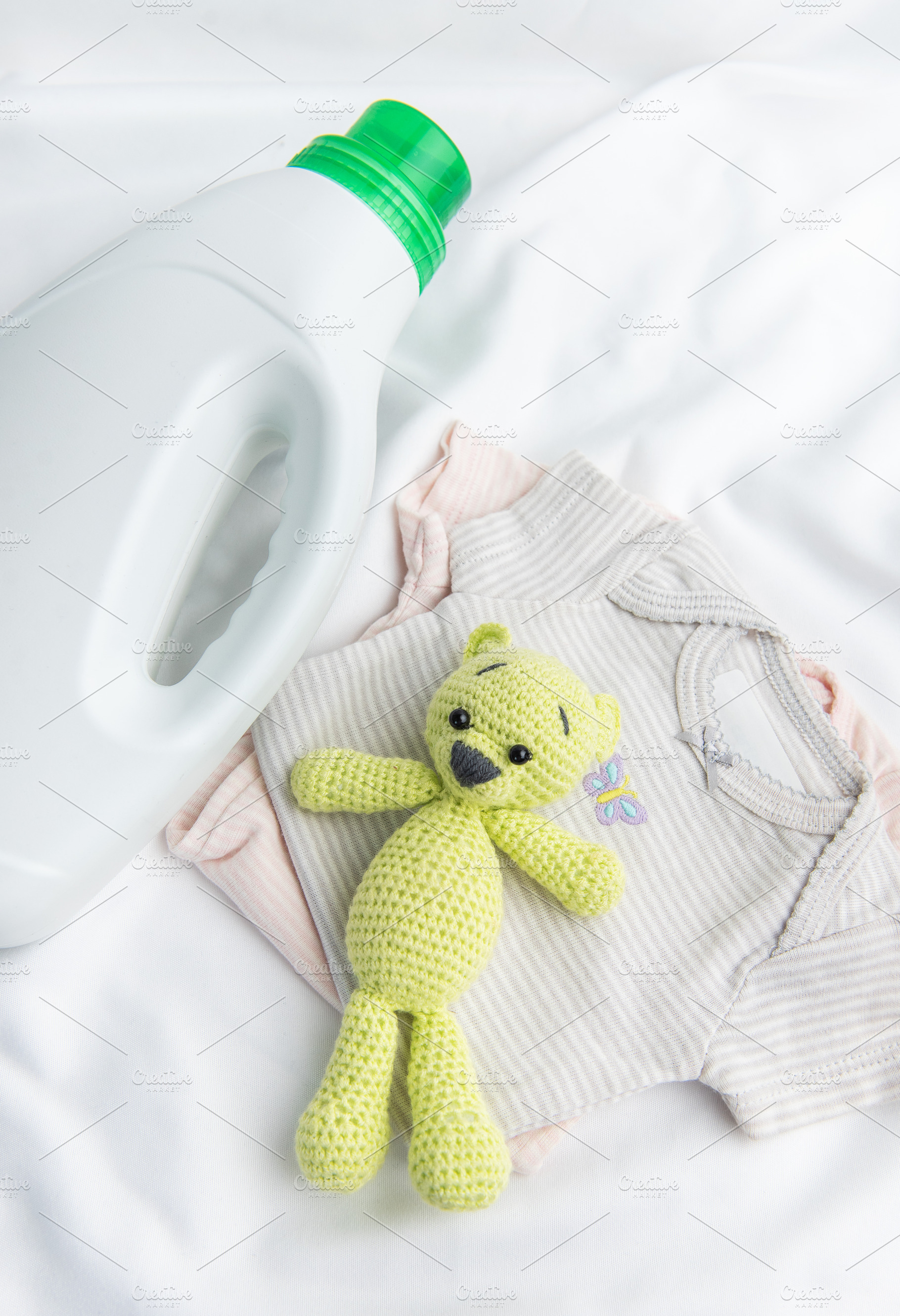 Detergent bottle, baby clothes, and toy bear for childcare, an Industrial Photo by Olena Rudo