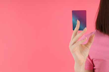 Woman in t-shirt holds card on pink background, a Person Photo by AtlasStudio PRO