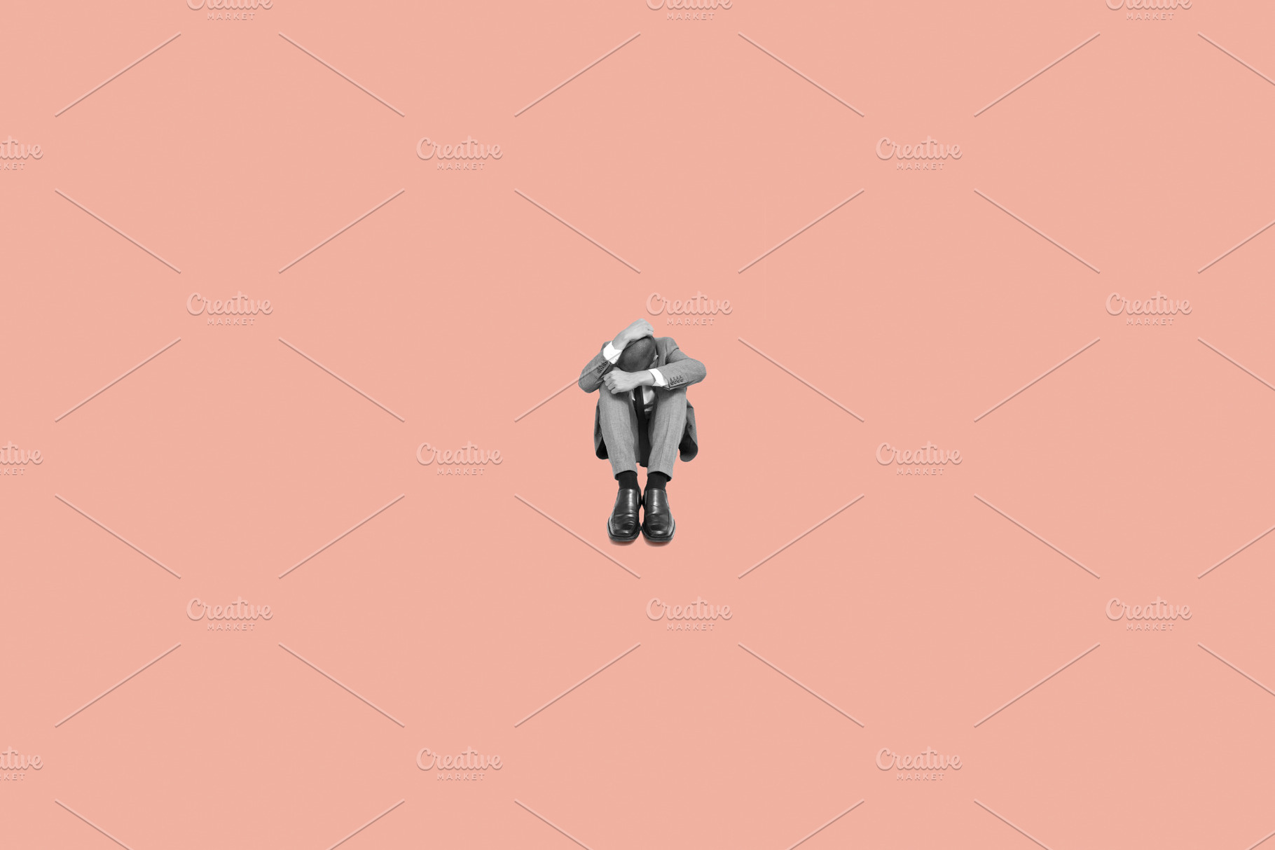 sad businessman curled up in the floor, a Photo by Nito