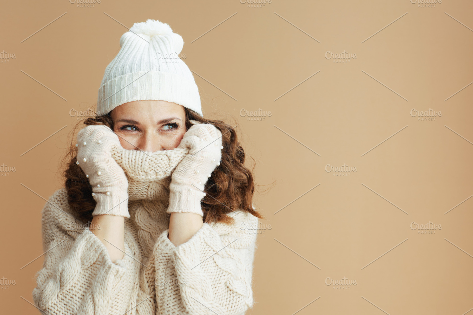 stylish woman isolated on beige background wrapped in collar, a Person Photo by Alliance Images
