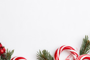 Christmas candy canes with red berries and evergreen branches, a Food & Drink Photo by José Manuel Gelpi