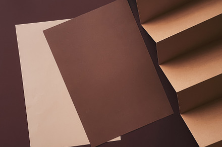 Beige and brown A4 papers as office stationery flatlay, luxury b, a Business Photo by Anneleven